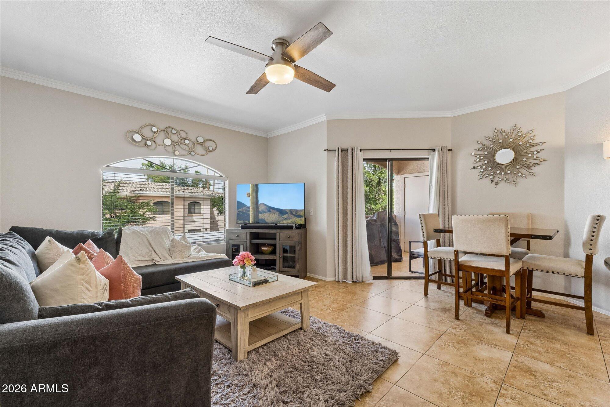 10030 West Indian School Road, Unit 269 Phoenix, AZ 85037 - Photo 29 of 29 a living room with furniture a rug and a chandelier