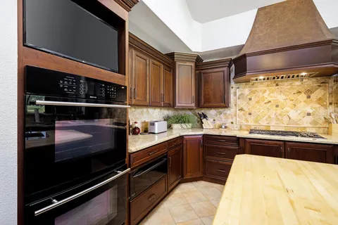 a kitchen with a stove a sink and a refrigerator