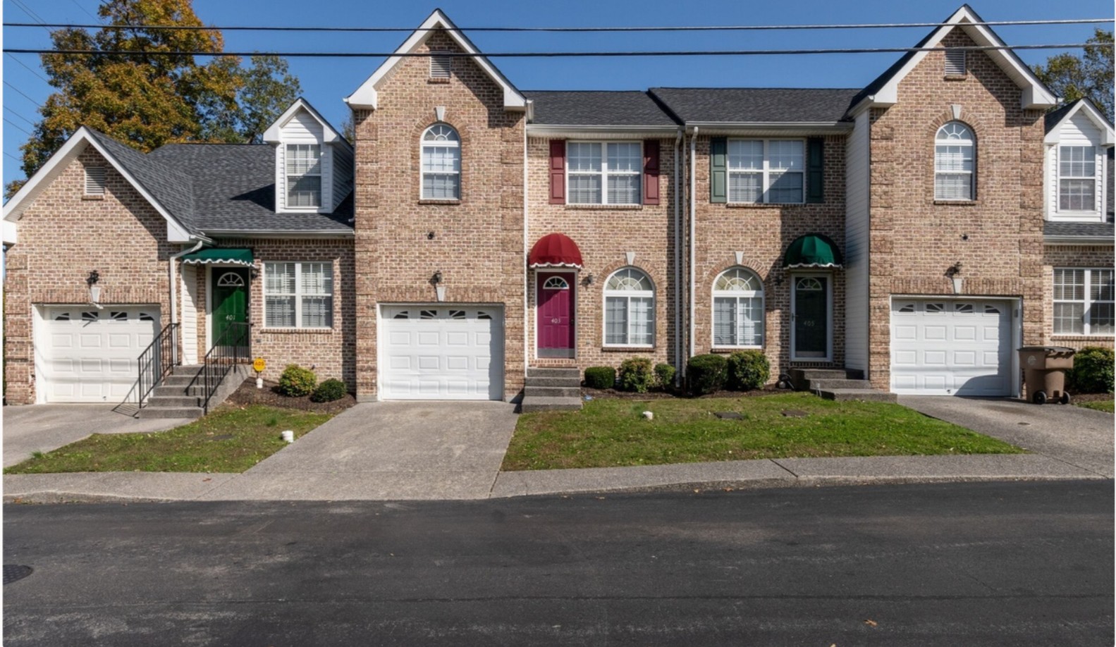 3001 Hamilton Church Road, Unit 403 Antioch, TN 37013 - Photo 1 of 21 a front view of a house with a yard and garage