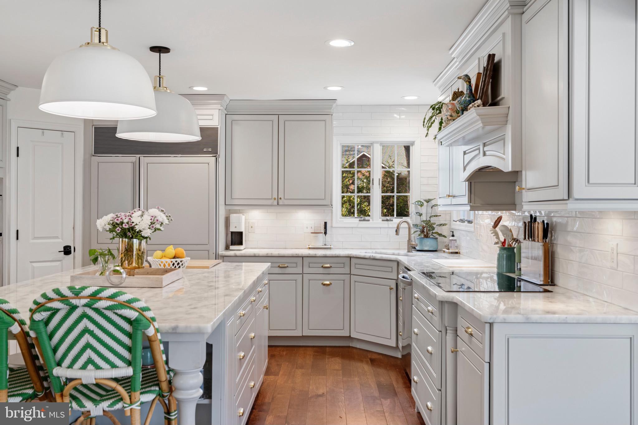 3618 Jackson Cabin Road Phoenix, MD 21131 - Photo 33 of 68 a kitchen with a sink dishwasher a stove a dining table and chairs with wooden floor