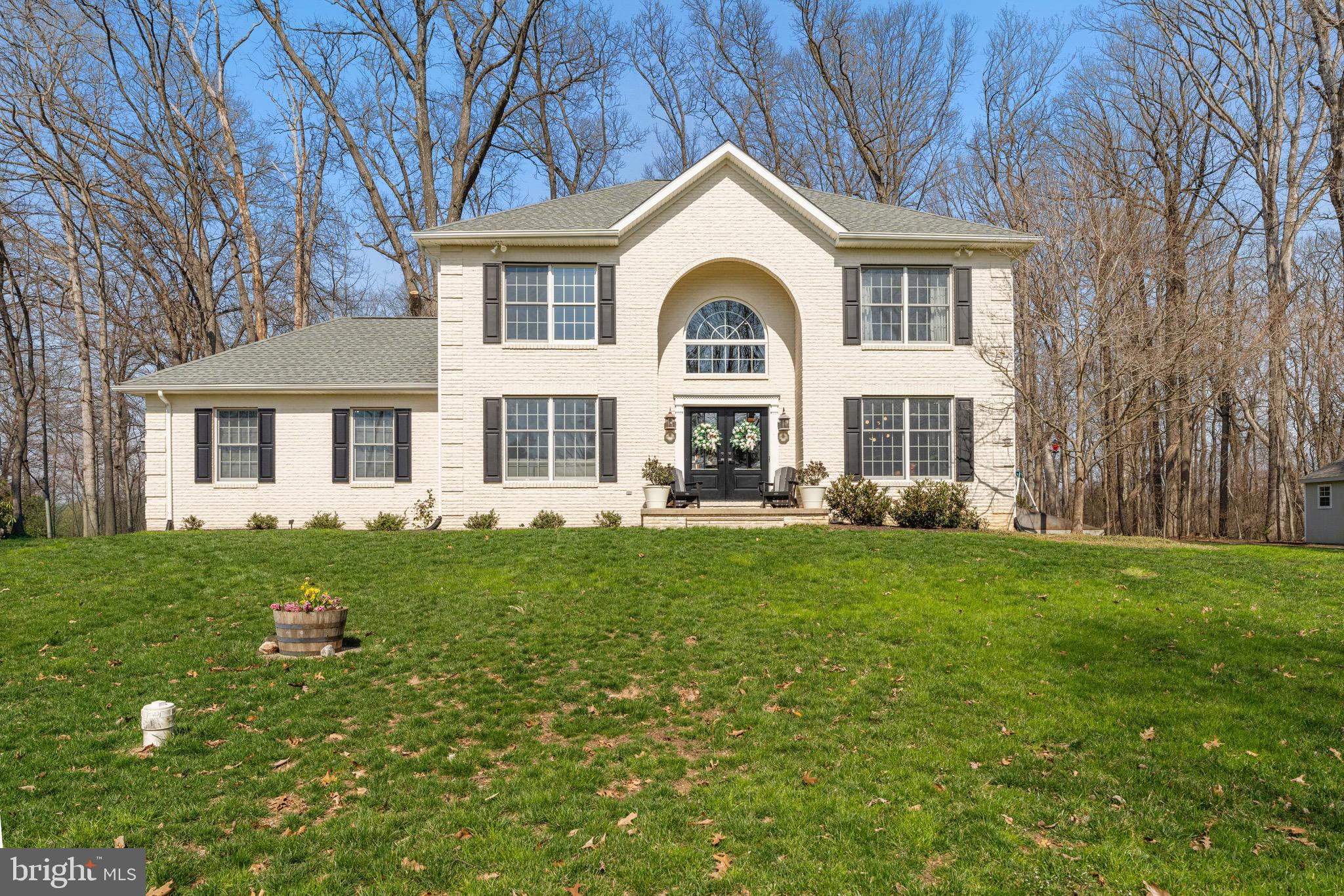 3618 Jackson Cabin Road Phoenix, MD 21131 - Photo 60 of 62 a front view of a house with a garden