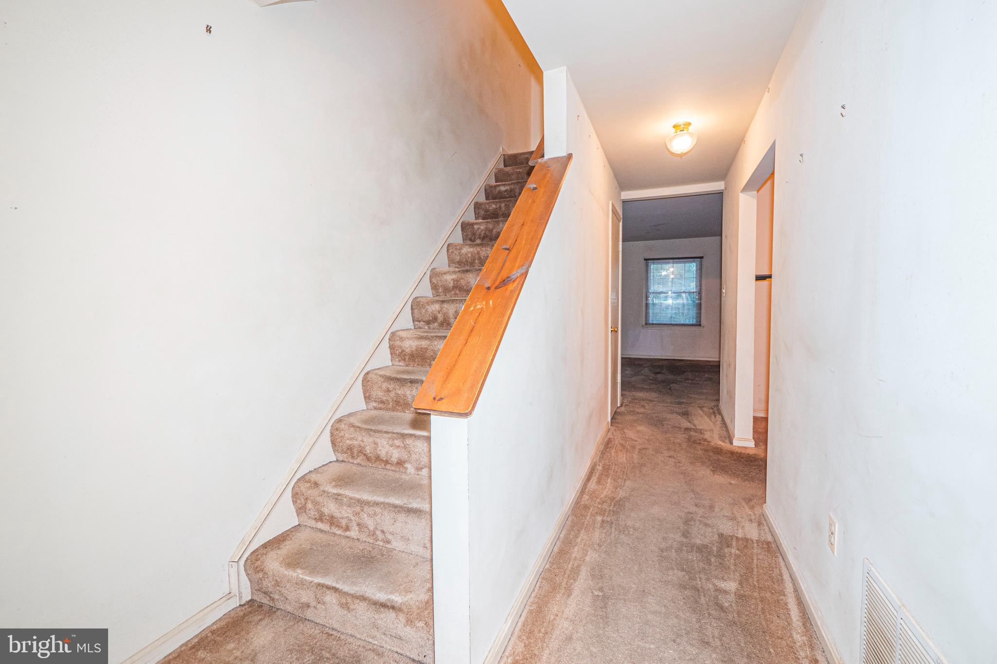 9610 Kanfer Court Gaithersburg, MD 20886 - Photo 4 of 41 a view of a hallway with wooden floor and staircase