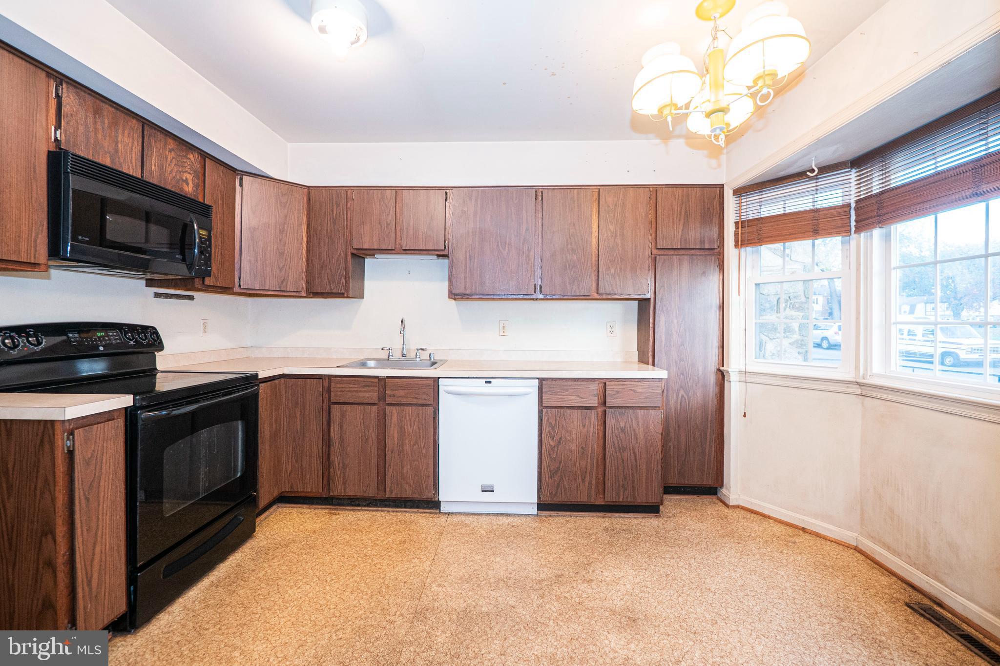 9610 Kanfer Court Gaithersburg, MD 20886 - Photo 5 of 41 a kitchen with stainless steel appliances granite countertop a stove a sink and a microwave