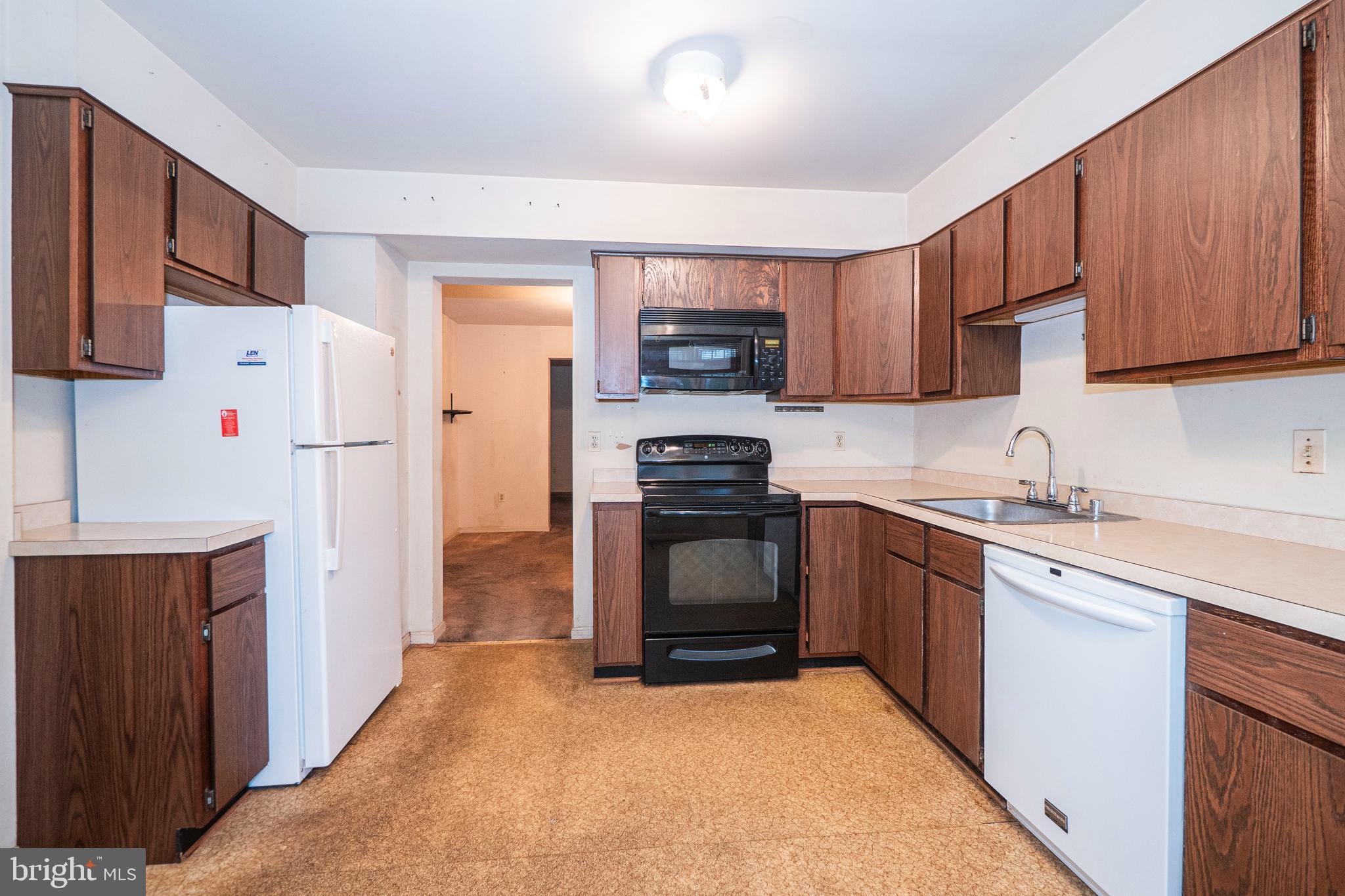 9610 Kanfer Court Gaithersburg, MD 20886 - Photo 6 of 41 a kitchen with stainless steel appliances granite countertop a refrigerator stove a sink and dishwasher with wooden cabinets