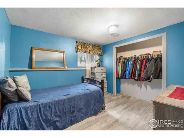 a bedroom with a large bed and a walk in closet