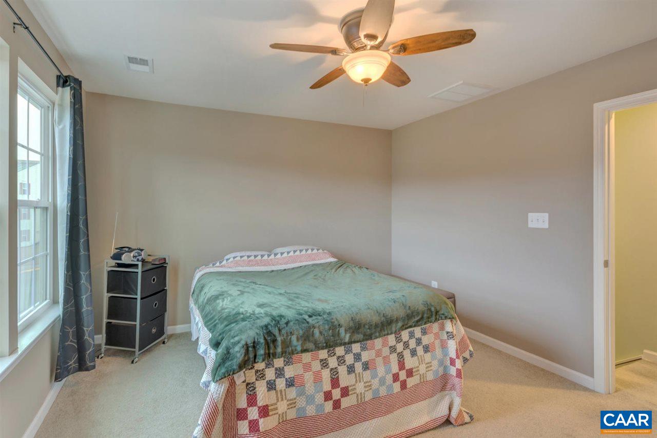 474 Rolkin Road Charlottesville, VA 22911 - Photo 13 of 42 a bedroom with a bed and a chandelier