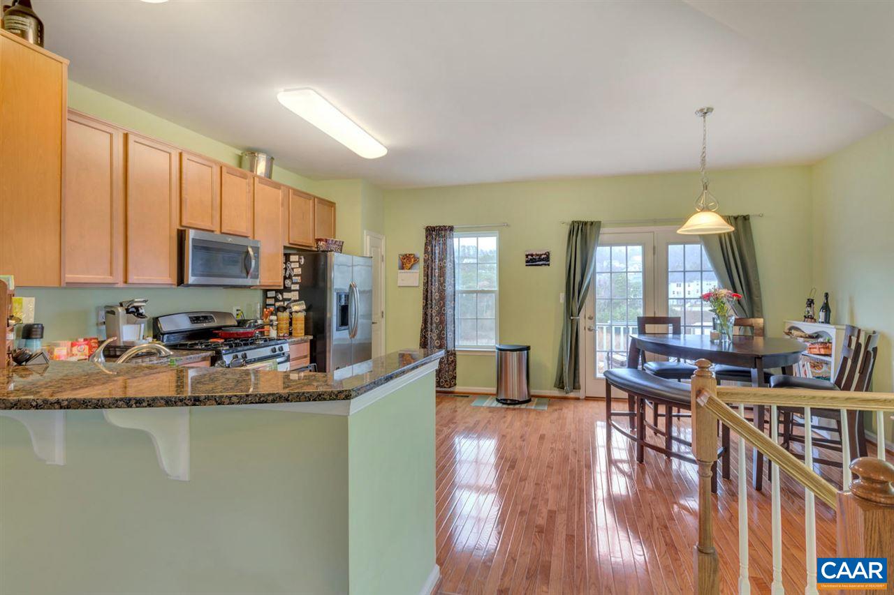 474 Rolkin Road Charlottesville, VA 22911 - Photo 7 of 42 a kitchen with sink a refrigerator and chairs