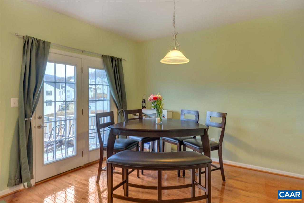 474 Rolkin Road Charlottesville, VA 22911 - Photo 9 of 42 a view of a dining room with furniture wooden floor and chandelier