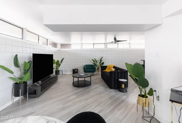 a living room with furniture and a chandelier