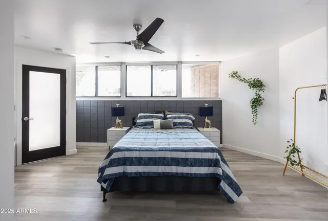 a room with a bed and a wooden floor