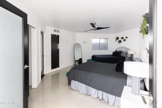 a bedroom with bed and a chandelier