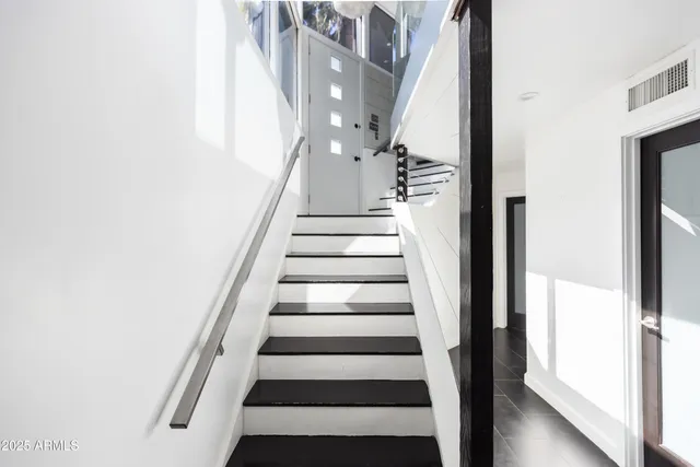 a view of staircase with white walls
