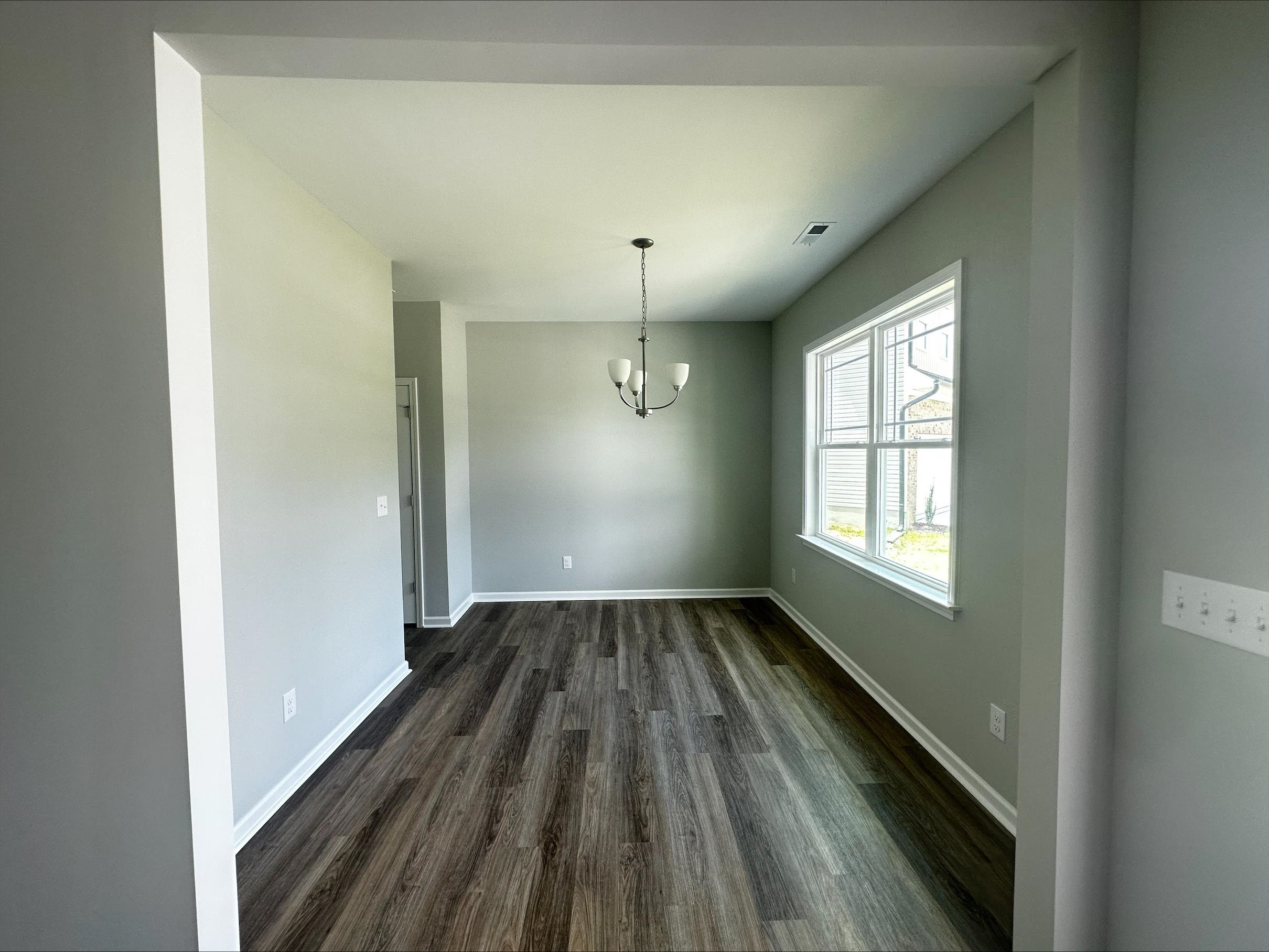40 Daffodil Garden Smithfield, NC 27577 - Photo 3 of 17 a view of an empty room with wooden floor and a window