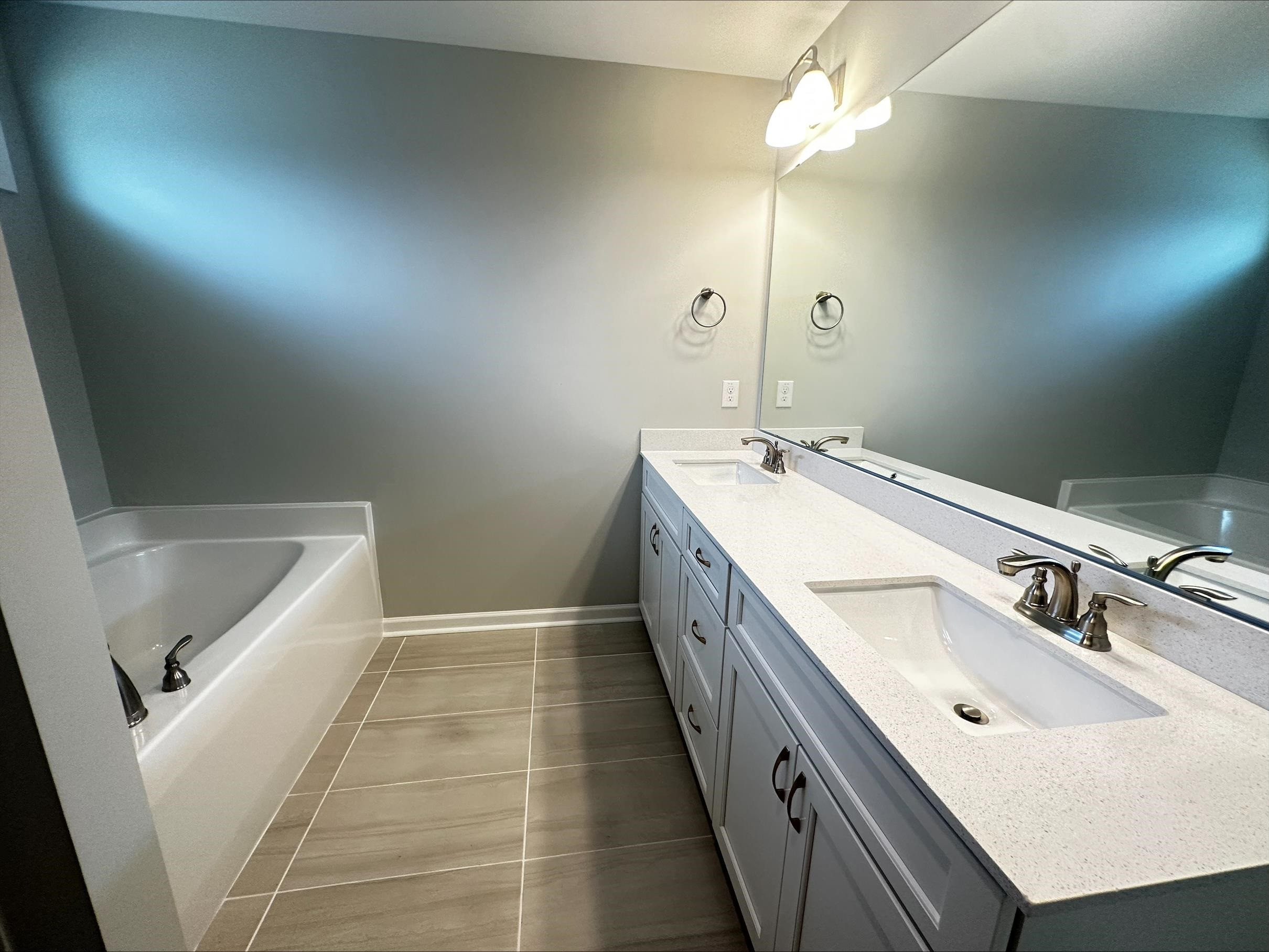 40 Daffodil Garden Smithfield, NC 27577 - Photo 9 of 17 a bathroom with a sink a vanity and a mirror