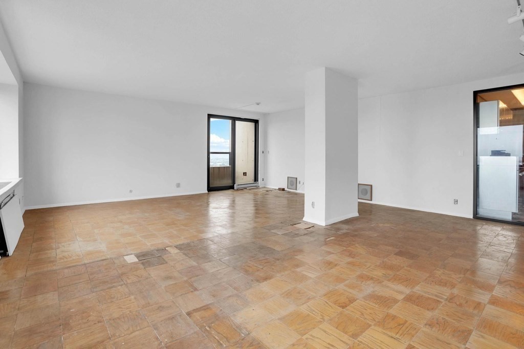 65 East India Row, Unit PHB Boston, MA 02110 - Photo 5 of 24 a view of an empty room with window and wooden floor