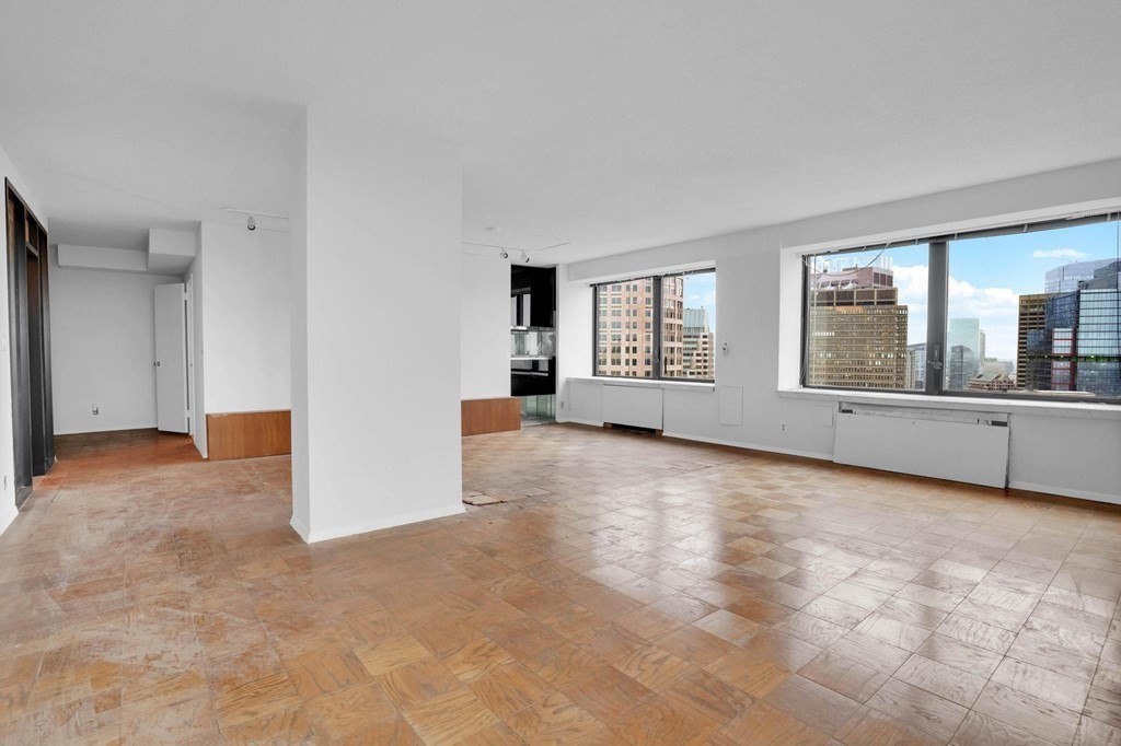 65 East India Row, Unit PHB Boston, MA 02110 - Photo 6 of 24 a view of an empty room with a window