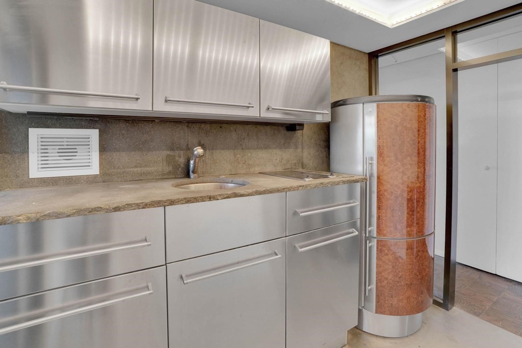 65 East India Row, Unit PHB Boston, MA 02110 - Photo 8 of 24 a kitchen with stainless steel appliances granite countertop a refrigerator and a cabinets