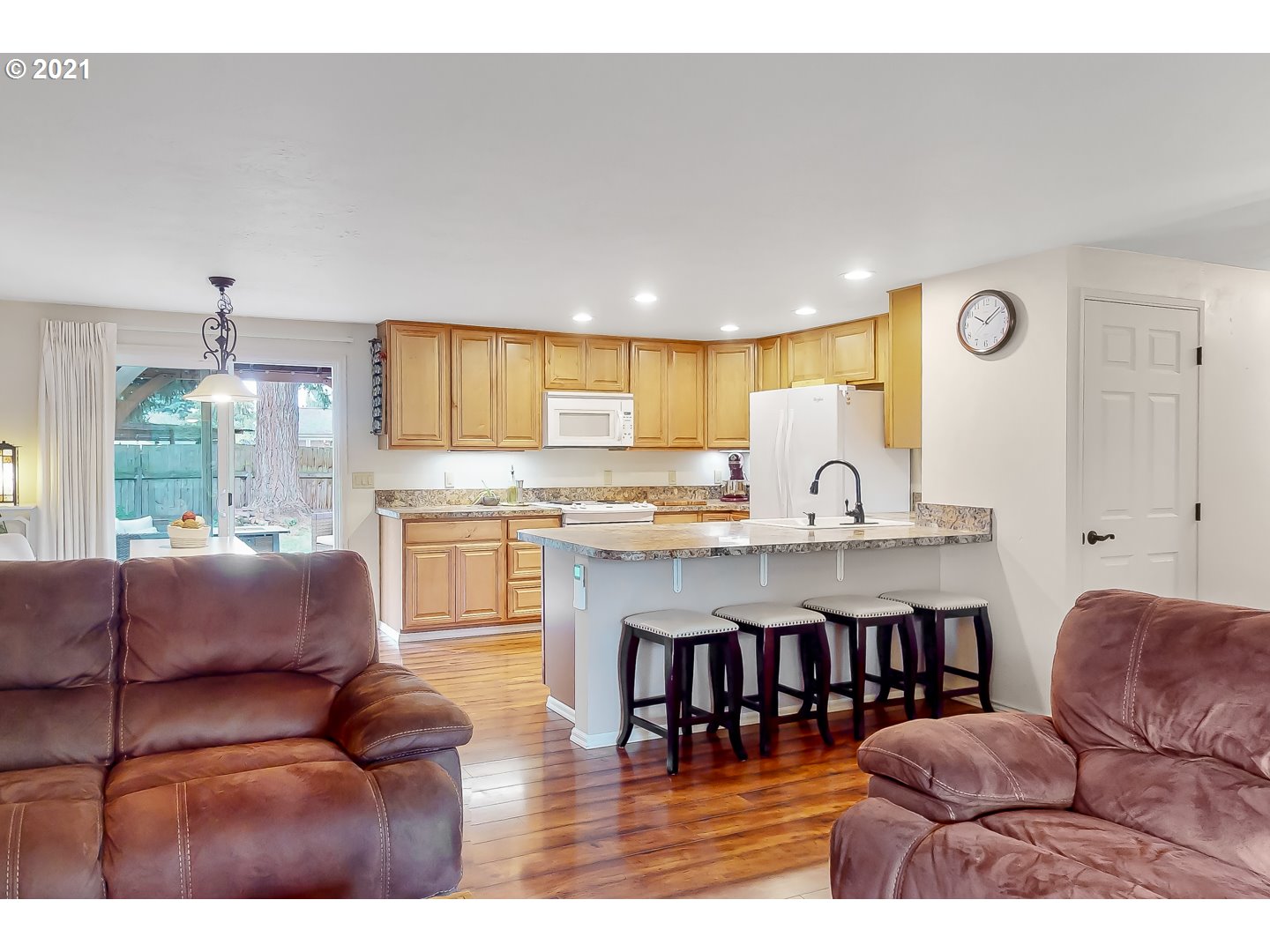 2486 York Street Eugene, OR 97404 - Photo 6 of 31 a living room with stainless steel appliances kitchen island granite countertop a couch a dining table and chairs