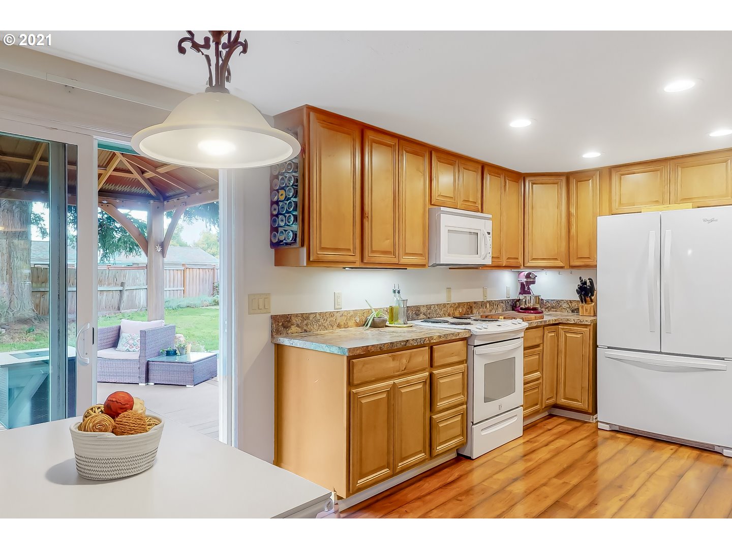 2486 York Street Eugene, OR 97404 - Photo 9 of 31 a kitchen with a refrigerator a stove top oven a sink with wooden floor
