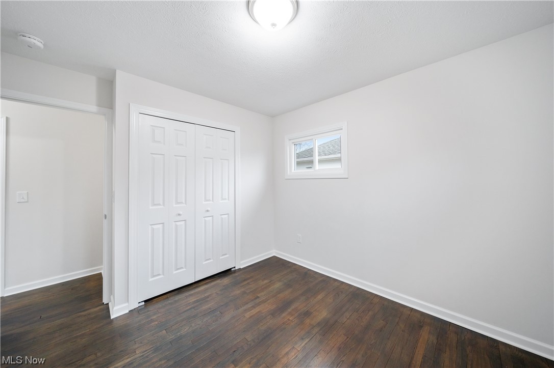 684 Sterling Road Wickliffe, OH 44092 - Photo 20 of 35 Unfurnished bedroom featuring dark hardwood / wood-style flooring and a closet
