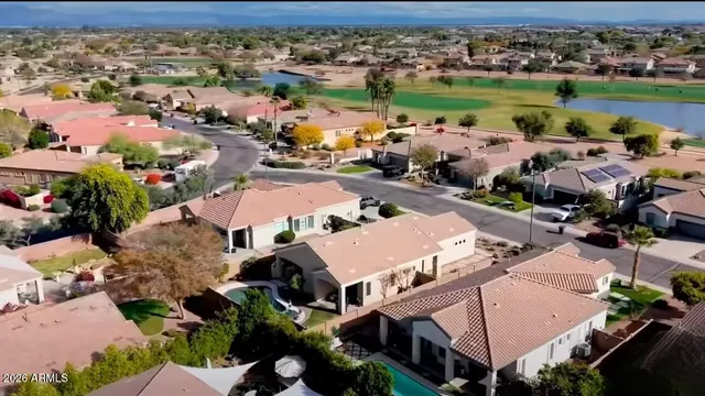 an aerial view of a building with outdoor space swimming pool and ocean view