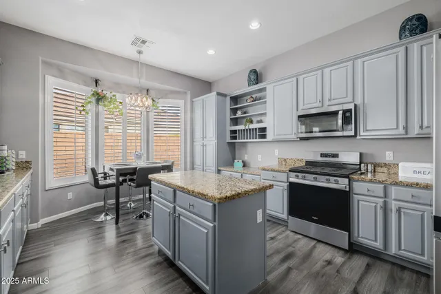 a view of a chair and table in backyard of the house