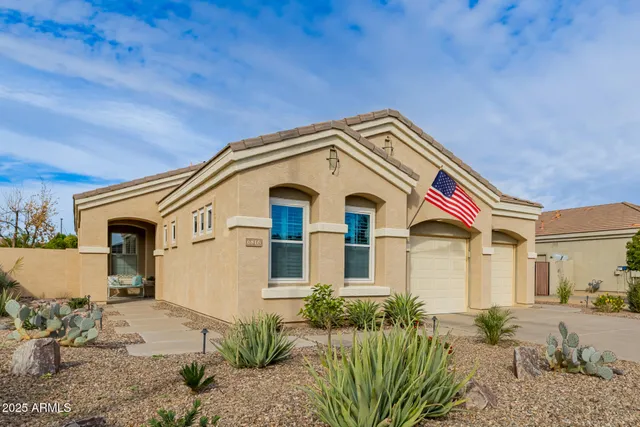 a kitchen with stainless steel appliances kitchen island granite countertop a table and chairs in it