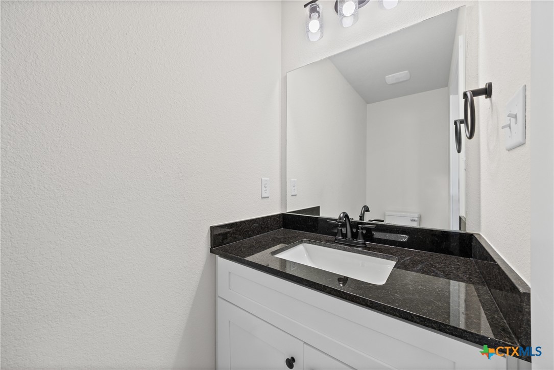 1407 South 5th Street Temple, TX 76504 - Photo 18 of 33 a sink and a mirror