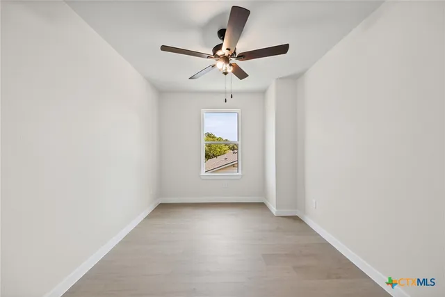 a view of room with window and ceiling fan