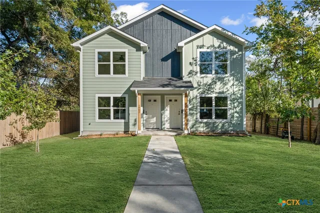 a front view of a house with a yard