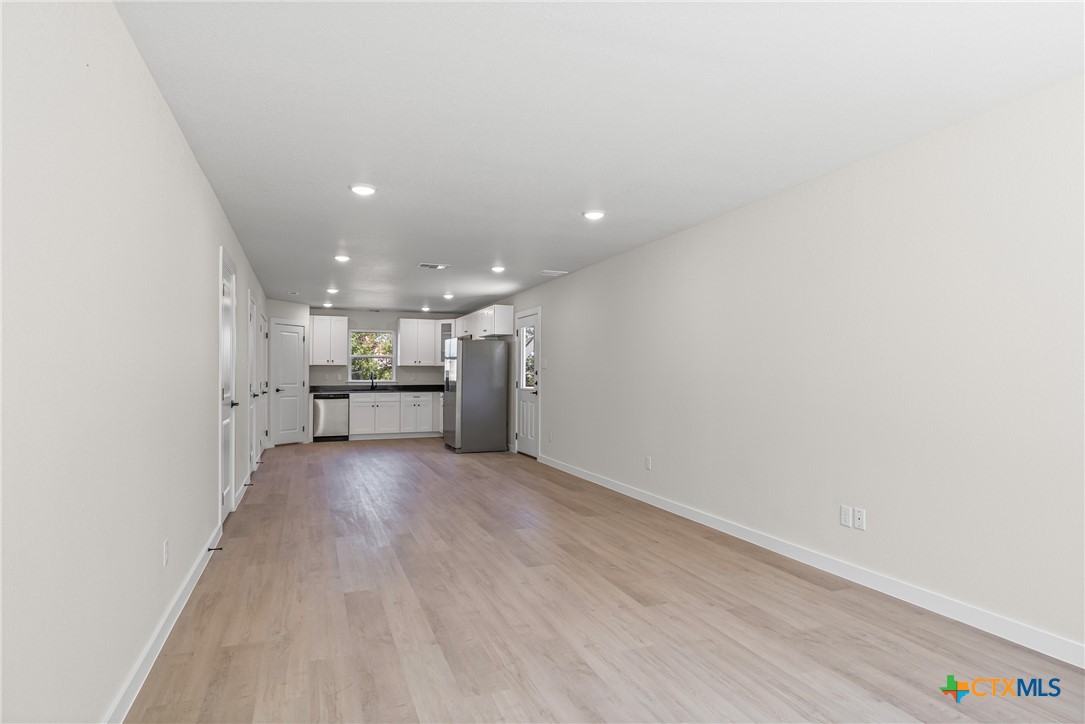 1407 South 5th Street Temple, TX 76504 - Photo 10 of 33 a view of a kitchen with a sink and a refrigerator