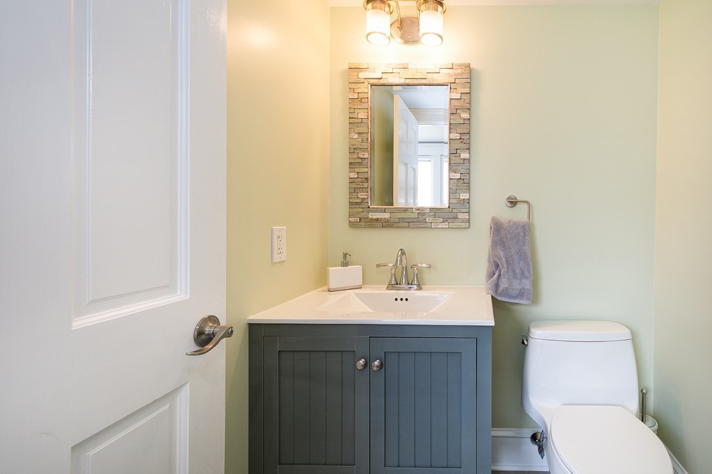 38 First Parish Road Scituate, MA 02066 - Photo 12 of 26 a bathroom with a toilet sink and mirror