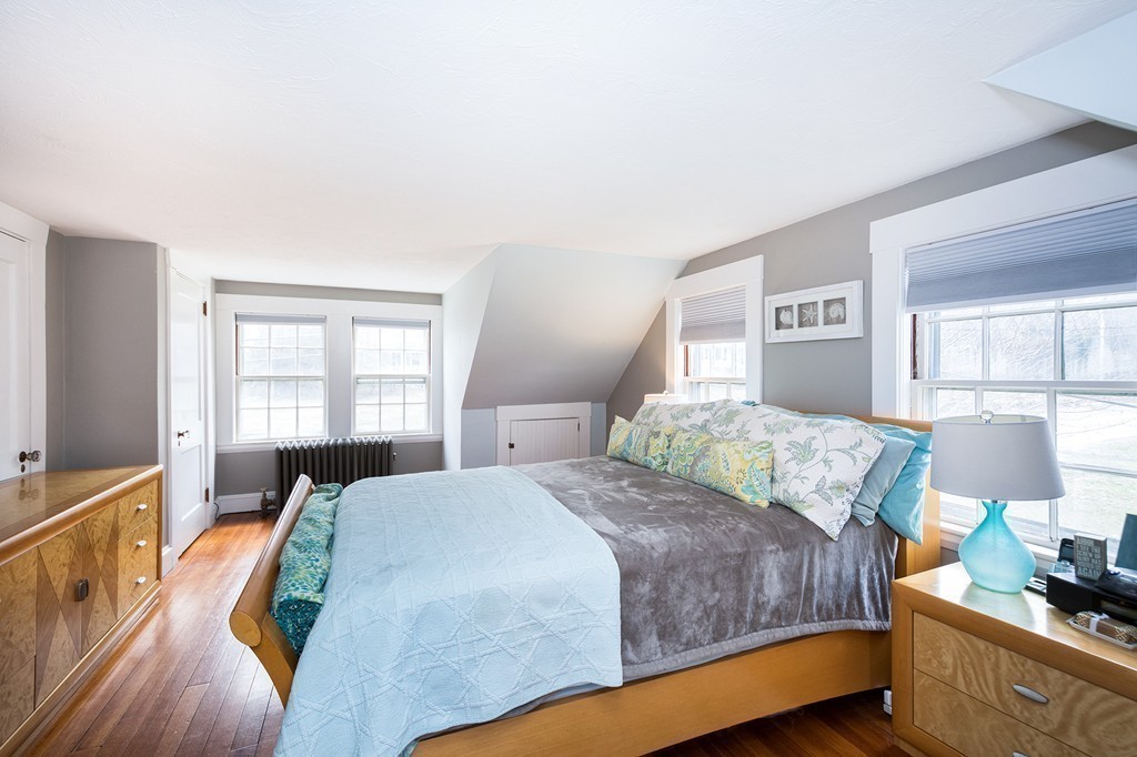 38 First Parish Road Scituate, MA 02066 - Photo 16 of 26 a bedroom with a bed and wooden floor