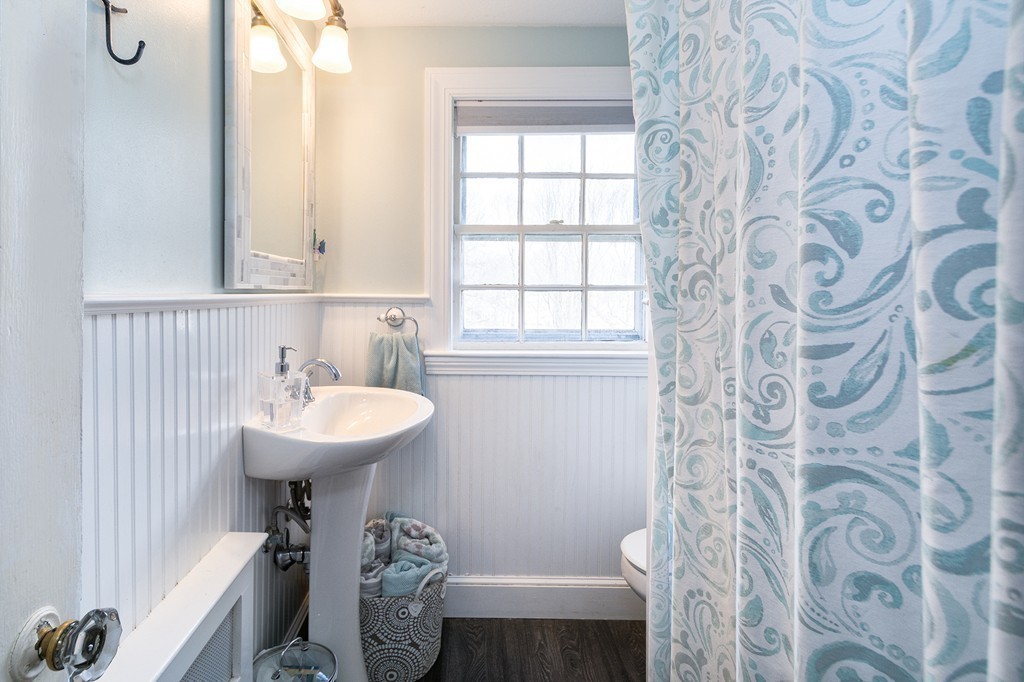 38 First Parish Road Scituate, MA 02066 - Photo 18 of 26 a bathroom with a sink toilet and shower