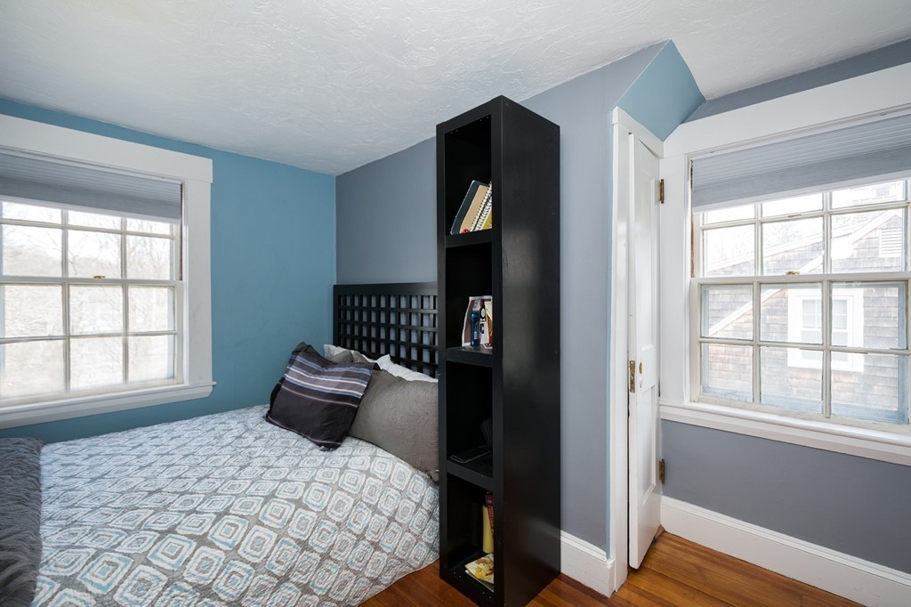 38 First Parish Road Scituate, MA 02066 - Photo 19 of 26 a bedroom with a bed and wooden floor