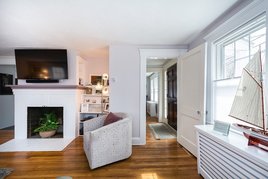 38 First Parish Road Scituate, MA 02066 - Photo 6 of 26 a living room with furniture a flat screen tv and a fireplace