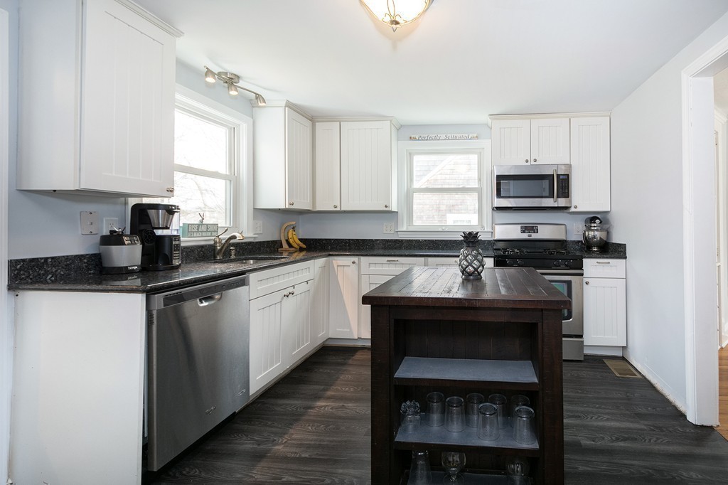 38 First Parish Road Scituate, MA 02066 - Photo 7 of 26 a kitchen with a stove a sink and a refrigerator