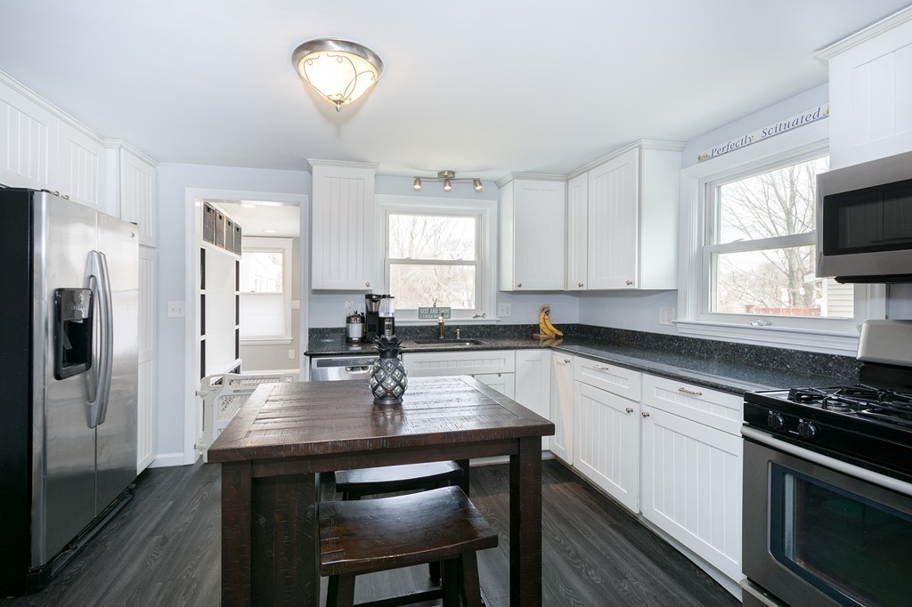 38 First Parish Road Scituate, MA 02066 - Photo 8 of 26 a kitchen with refrigerator cabinets dining table and chairs