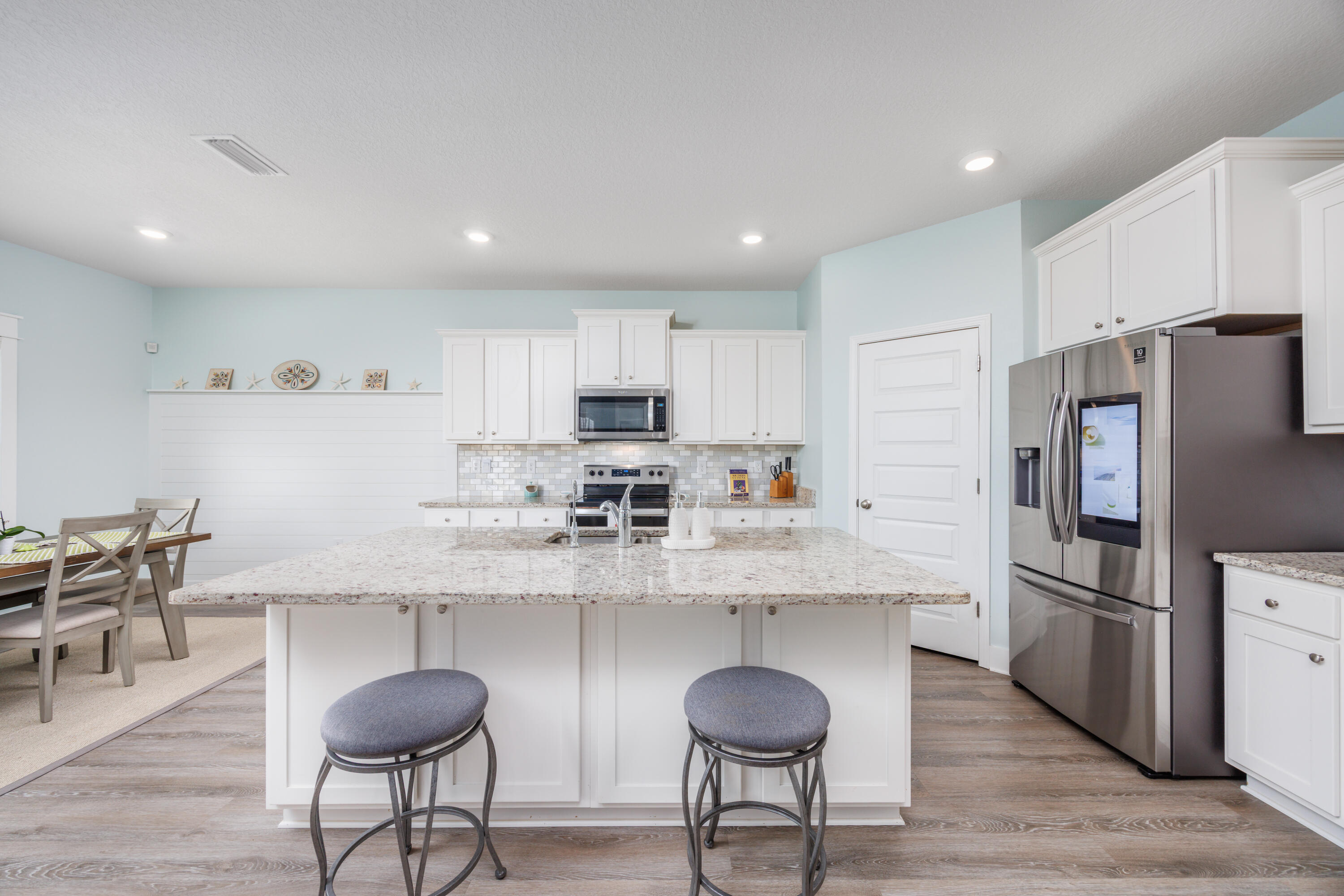 193 Perimeter Place Freeport, FL 32439 - Photo 12 of 43 a kitchen with granite countertop a center island stainless steel appliances cabinets and a counter space