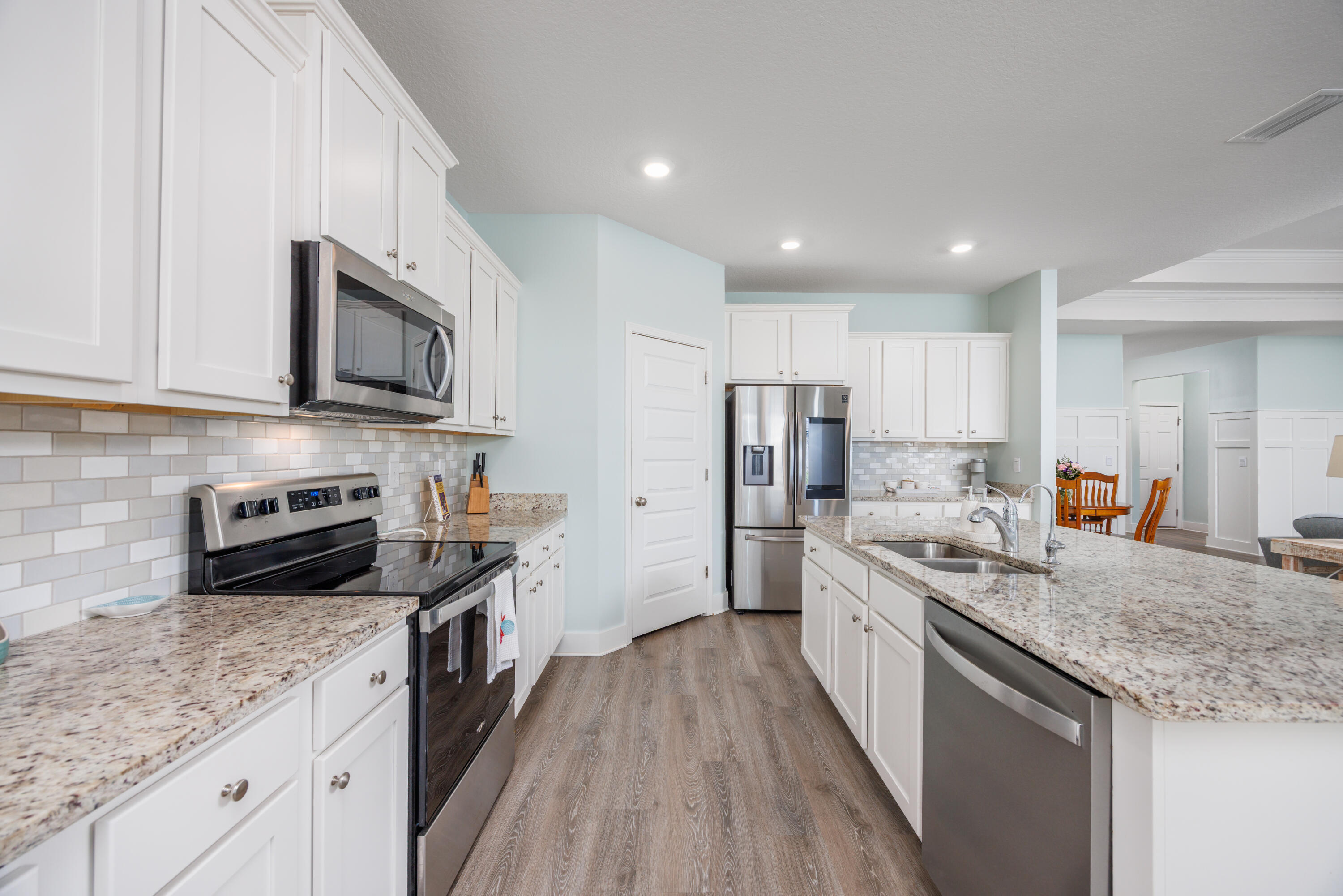 193 Perimeter Place Freeport, FL 32439 - Photo 14 of 43 a kitchen with stainless steel appliances granite countertop a sink stove microwave and refrigerator