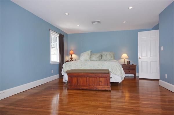 21 Elmwood Road Wellesley, MA 02481 - Photo 15 of 27 a bedroom with a bed and wooden floor