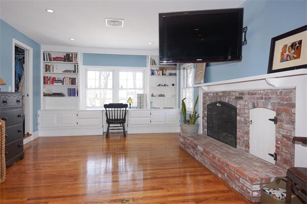 21 Elmwood Road Wellesley, MA 02481 - Photo 16 of 27 a living room with furniture a flat screen tv and a fireplace
