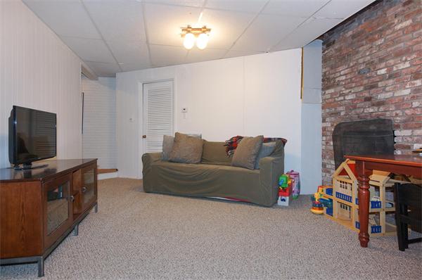 21 Elmwood Road Wellesley, MA 02481 - Photo 24 of 27 a living room with furniture and a flat screen tv