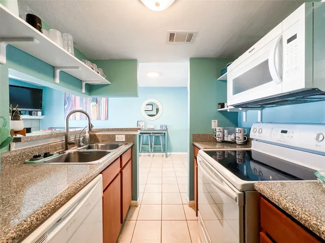 a kitchen with a sink and a stove top oven
