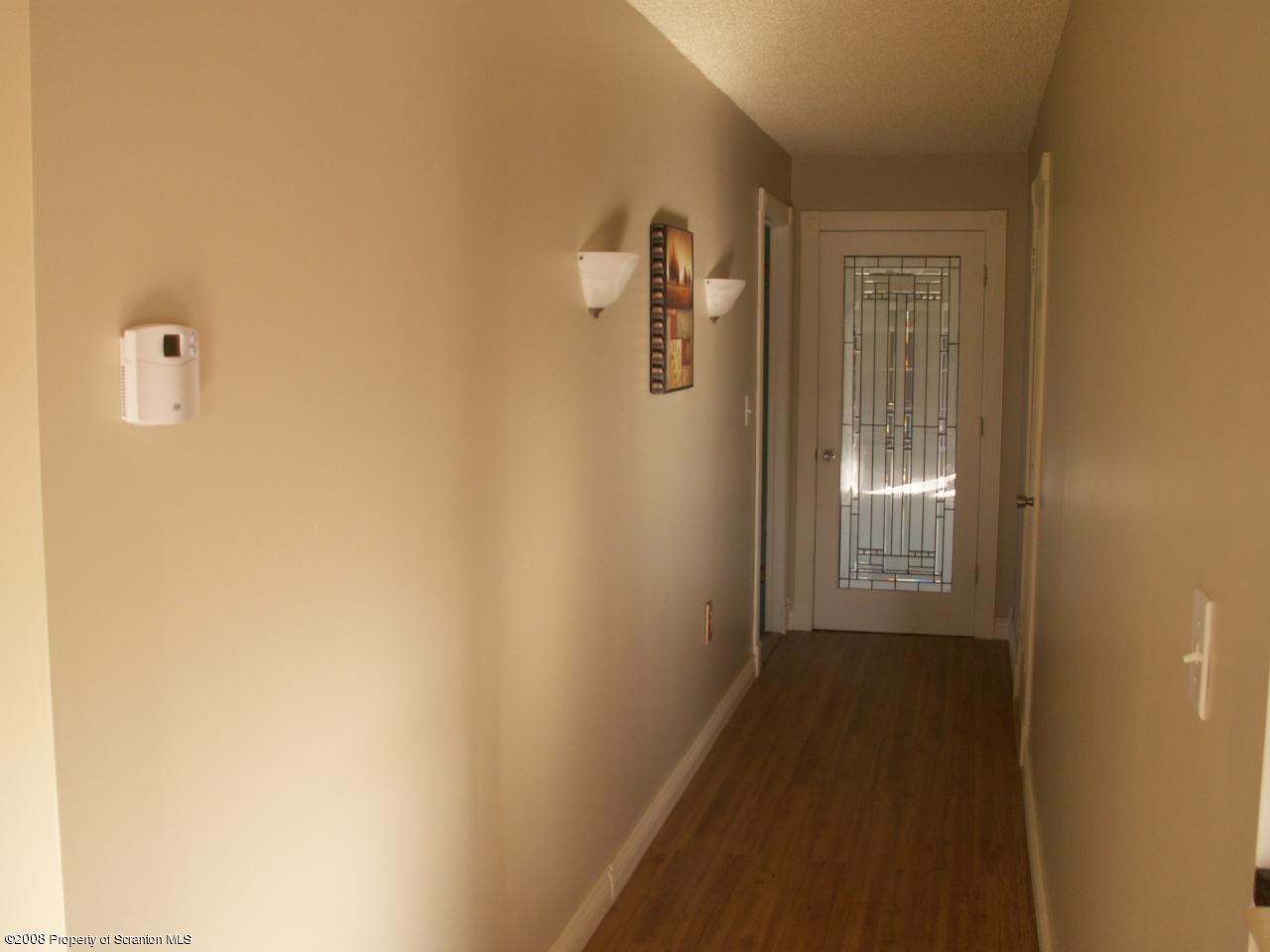0 Rr 1 Meshoppen, PA 18630 - Photo 9 of 25 a view of a hallway with wooden floor and a bathroom