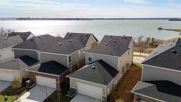 an aerial view of houses with an outdoor space and seating