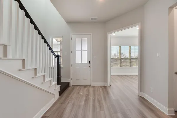 a view of an entryway with wooden floor and door
