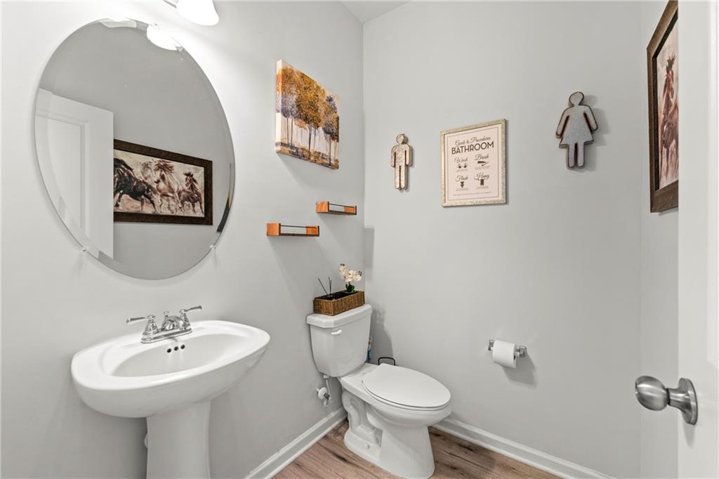 7492 Knoll Hollow Road Lithonia, GA 30058 - Photo 14 of 30 a bathroom with a toilet a sink and mirror