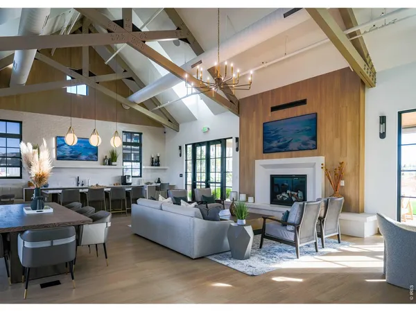 a living room with couches and a painting on the wall