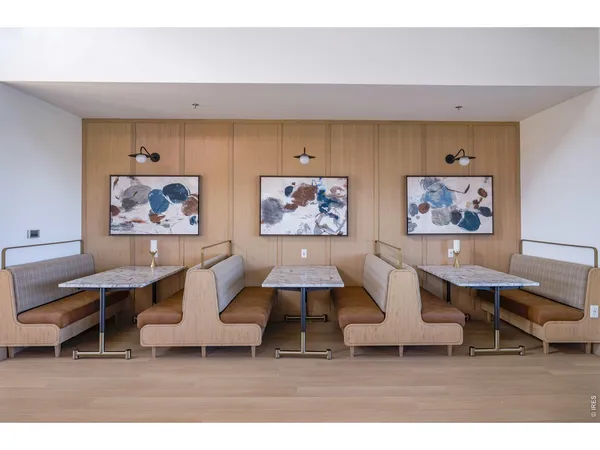 a kitchen with a dining table chairs sink and cabinets